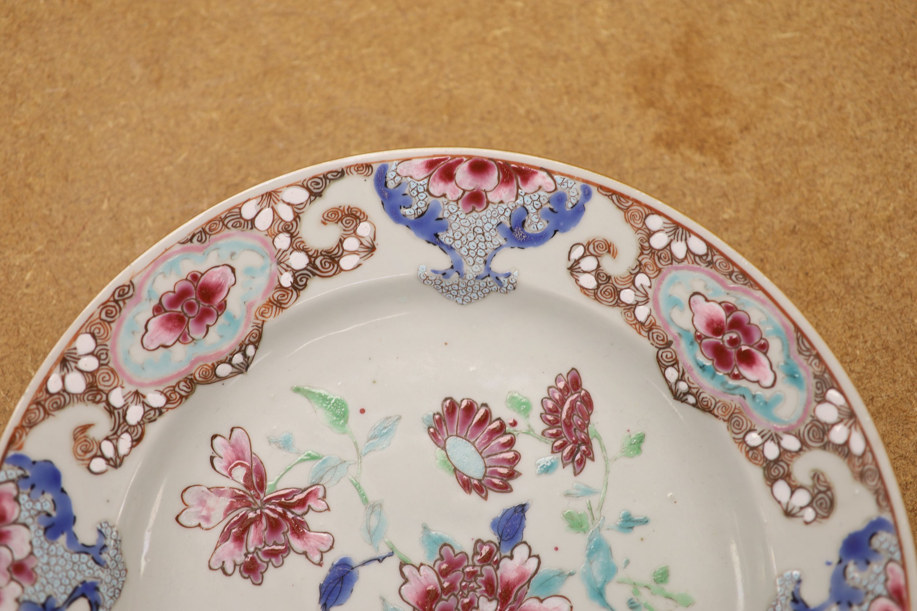 A pair of 18th century Chinese famille rose plates and another similar, largest diameter 22.5cm (damage)